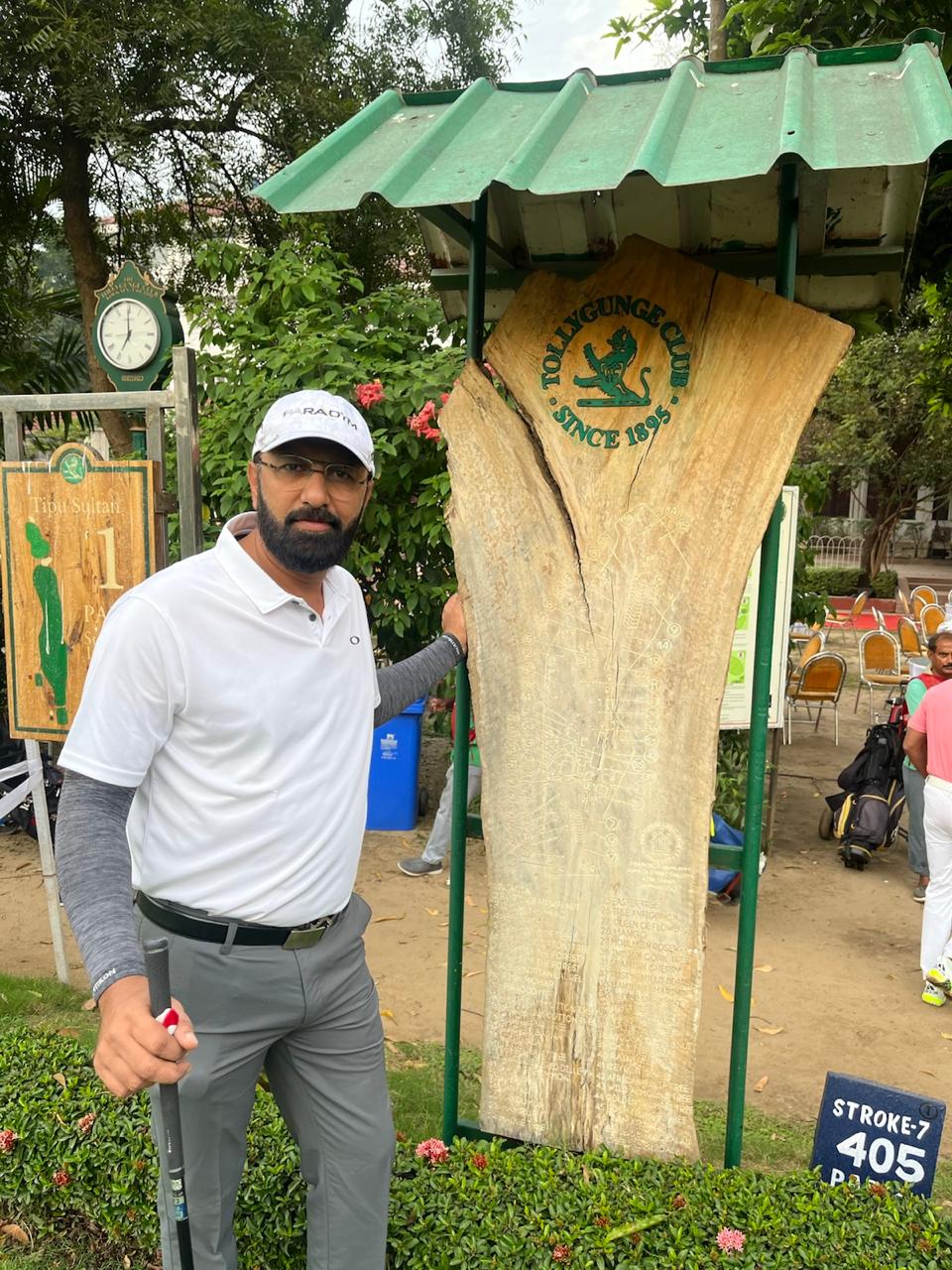 Govind Raj beside a carved tree trunk at a golf course