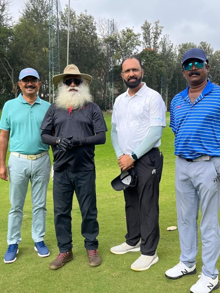 Govind Raj with golfers on a fairway