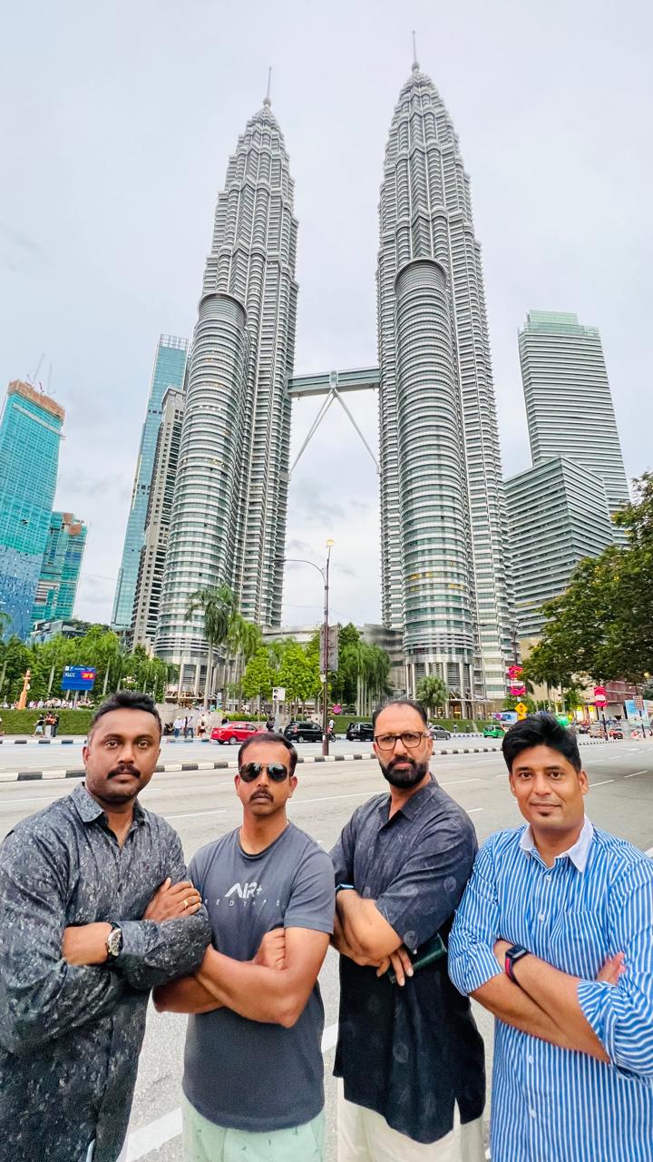 Govind Raj with colleagues in front of the Petronas Twin Towers